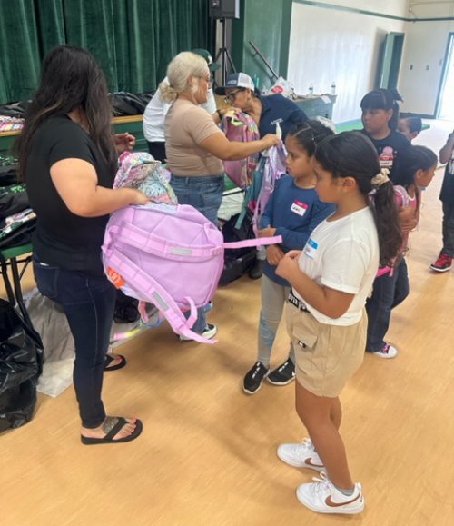 Students get a closer look at items from Standridge Partners.